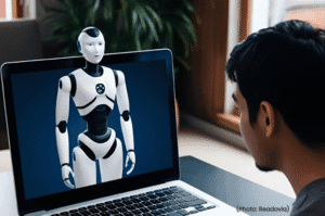 Humanoid robot on laptop - person using AI