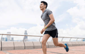 Young Asian man running.