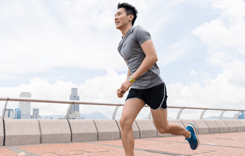 Young Asian man running.