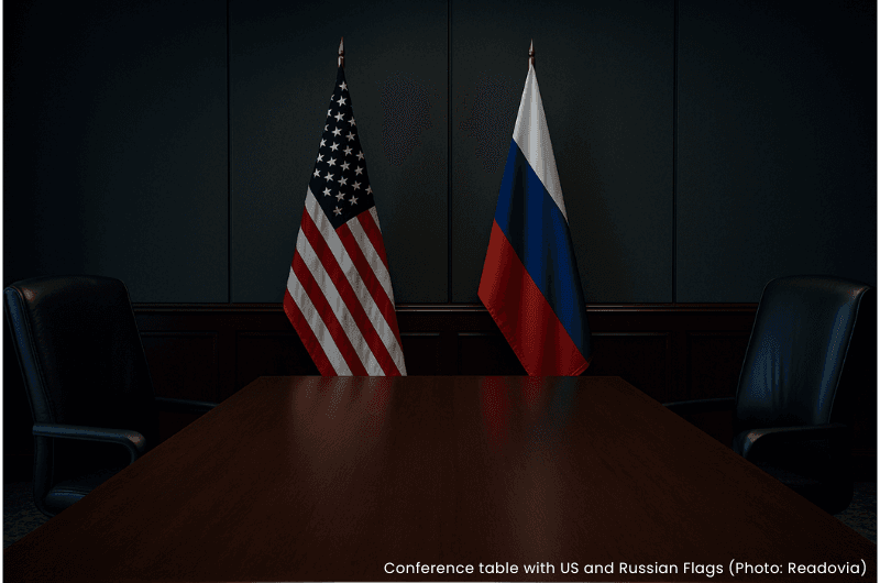Conference table with US and Russian flags