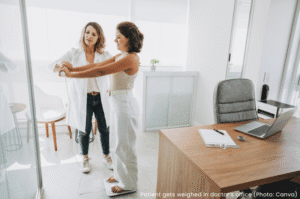 Patient gets weighed in doctor's office