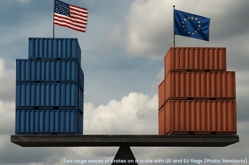 Two large stacks of crates with US and EU flags placed on a scale