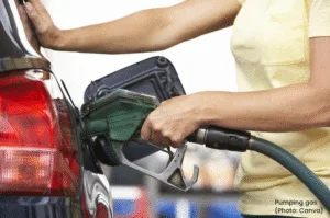 Person pumping gas at gas station