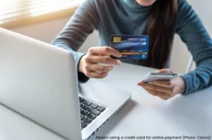 Person using a credit card for an online purchase