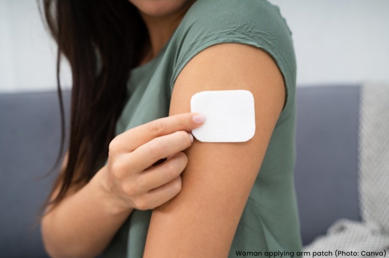 Woman applying arm patch