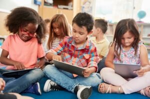 Young school kids in class using tablet computers