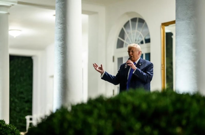 President Trump speaks with guests at a rose garden dinner