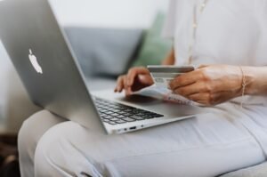 Woman using a credit card to make an online purchase