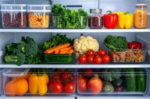 Organized refrigerator with a variety of fresh fruits and vegetables