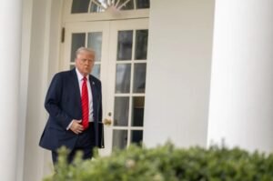 President Donald Trump walks along the West Wing colonnade of the White House.