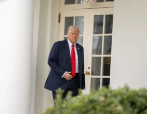 President Donald Trump walks along the West Wing colonnade of the White House.