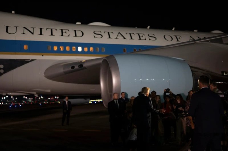 President Donald Trump speaks with reporters before boarding Air Force One at Palm Beach International Airport in West Palm Beach, Florida.