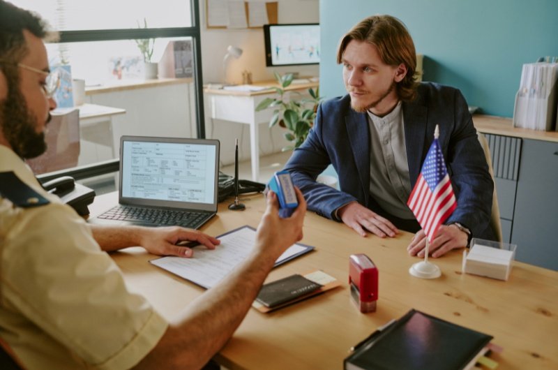 Immigrant meets with U.S. federal immigration officer.