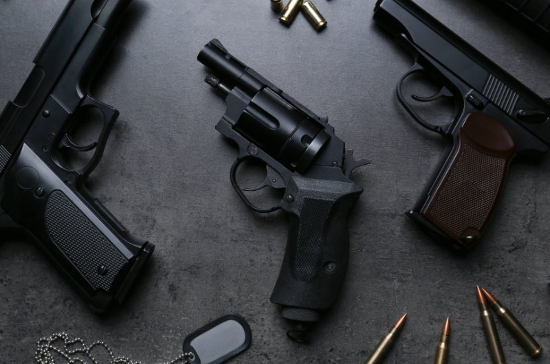 A set of firearms displayed on a dark surface, used to illustrate Australia’s newly announced national gun buyback initiative.