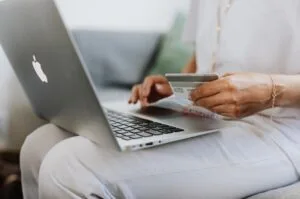 A woman uses her credit card for an online purchase.