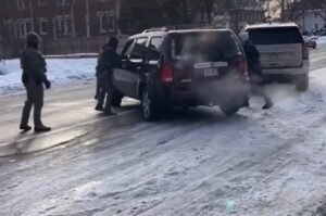 ICE officers and vehicles are seen at the scene of a Minneapolis immigration operation that ended in a fatal shooting.