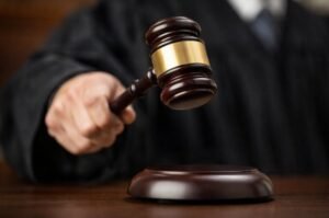 A judge’s gavel mid-strike reflects the judiciary’s role in shaping the outcome of a federal funding dispute.