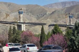 A major bridge near Tehran lies in ruins following a U.S. airstrike, marking a sharp escalation in the conflict.