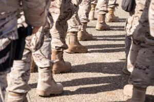 Boots on the ground reflect the human reality behind military readiness, as U.S. officials consider changes to how future service members are identified and prepared.