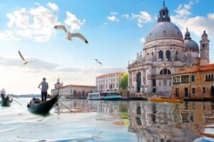 A gondola glides through Venice’s Grand Canal, capturing the timeless romance and beauty that define Italy’s most iconic destinations.