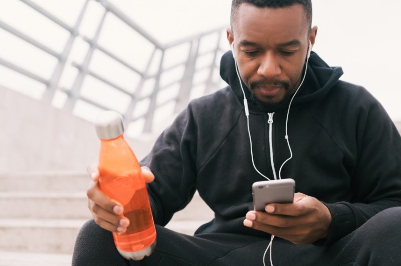 A man checks his phone during a quiet moment, highlighting how digital notifications have become part of everyday routines.