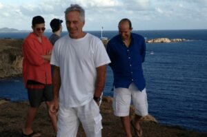 Jeffrey Epstein and Howard Lutnick, in blue shirt and white shorts.