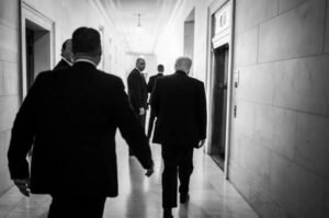 President Donald Trump walks through a courthouse hallway following another major legal setback tied to his administration’s trade policy efforts.