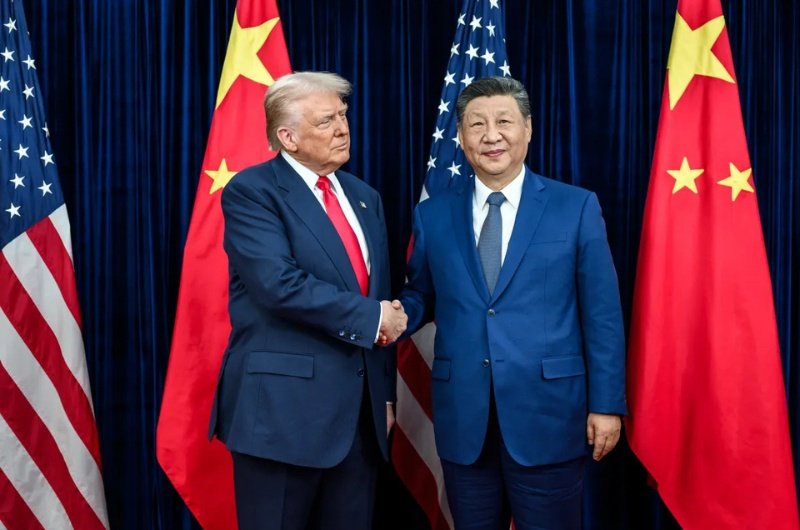 President Donald Trump and Chinese President Xi Jinping walk together during a high-stakes summit in Beijing focused on trade, AI, and global tensions.