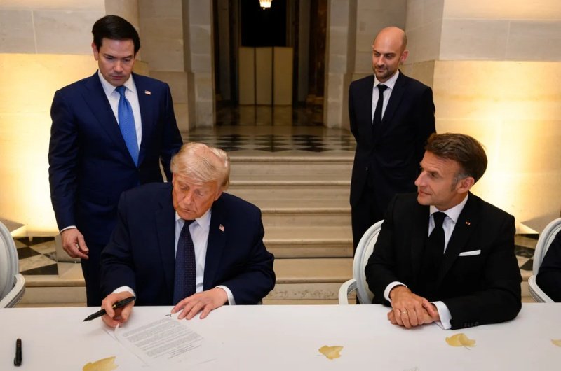 President Donald Trump signs the U.S.-Iran Memorandum of Understanding at the Palace of Versailles in France on June 17, 2026.