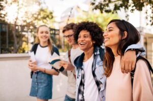 College students walk together on campus as new federal data points to improvements in youth mental health and substance-use trends.