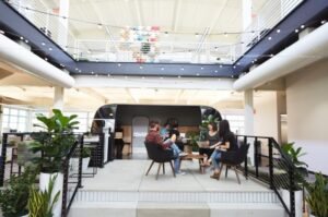 Google employees collaborate at one of the company's offices. Alphabet is increasing investment in AI infrastructure as demand for cloud computing and artificial intelligence services continues to grow.