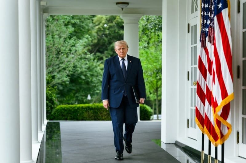 President Donald Trump walks along the White House colonnade ahead of a nationally televised primetime address scheduled for Thursday evening.