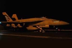 A U.S. Navy fighter jet prepares for nighttime operations as American forces continue strikes against targets in Iran.