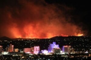 Wildfire burns along the hills above Reno, Nevada. Tens of thousands of residents in the Reno area are under evacuation orders or warnings as the Hawk Fire threatens surrounding communities.
