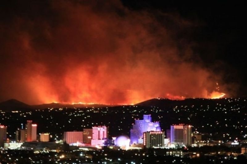 Wildfire burns along the hills above Reno, Nevada. Tens of thousands of residents in the Reno area are under evacuation orders or warnings as the Hawk Fire threatens surrounding communities.