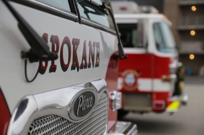 Spokane Fire Department vehicles stand ready as crews respond to destructive wildfires burning across the Spokane area. 