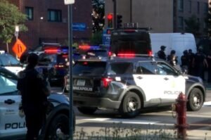 Minneapolis police respond to the scene of a deadly shooting at a downtown apartment building Wednesday, where two people were killed and six others were injured, including three police officers.