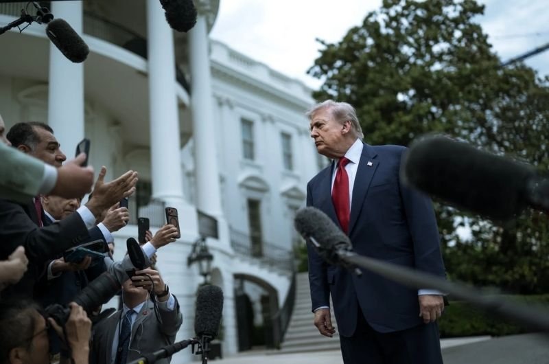 President Donald Trump speaks with members of the media on the South Lawn of the White House before boarding Marine One.
