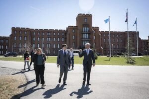 Officials walk outside a Department of Homeland Security facility during an official visit.