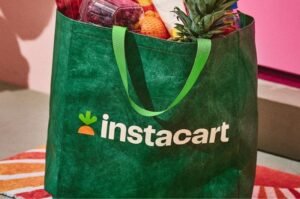 An Instacart grocery delivery bag. The company has agreed to a $5 million federal settlement resolving allegations of discriminatory hiring practices.