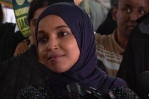 Rep. Ilhan Omar speaks with reporters. Federal agents searched her Washington, D.C., residence on October 12, 2026, as part of an ongoing investigation.